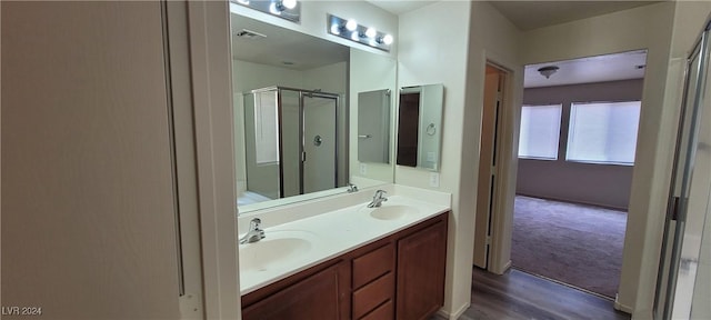 4085 Oliver Sagebrush Dr, Las Vegas, NV 89122 - bathroom featuring a shower stall, double vanity, and wood finished floors