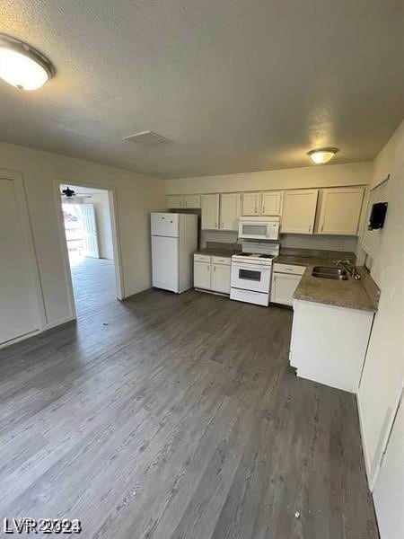 kitchen with ceiling fan, white cabinets, white appliances, sink, and dark hardwood / wood-style floors