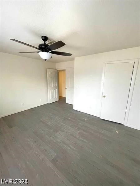 unfurnished room with ceiling fan and dark hardwood / wood-style floors