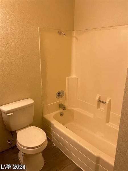 bathroom with toilet, shower / tub combination, and hardwood / wood-style flooring