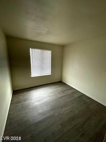 empty room with dark wood-type flooring