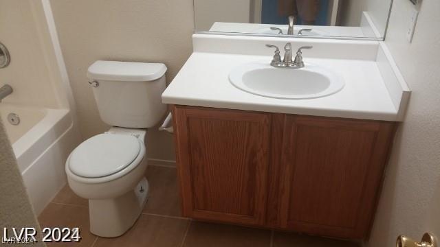 full bathroom with tile patterned flooring, vanity, tub / shower combination, and toilet