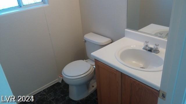 bathroom with tile patterned floors, vanity, and toilet