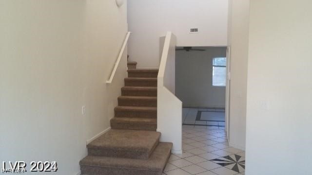 staircase with light tile patterned floors