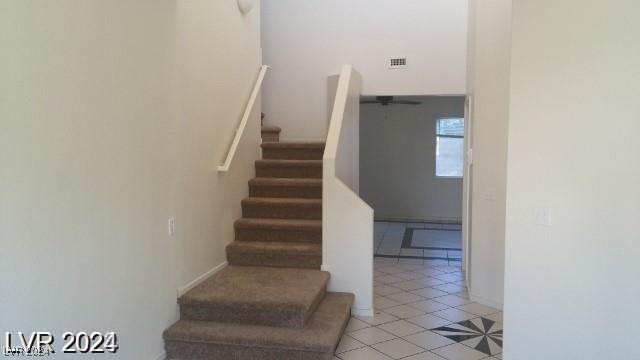 stairs featuring tile patterned floors