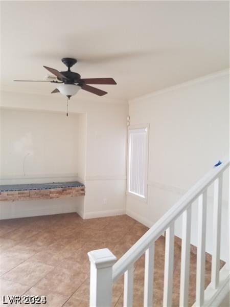 interior space featuring crown molding, light tile patterned floors, and ceiling fan