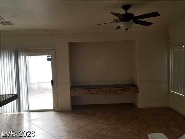 spare room featuring ornamental molding and ceiling fan