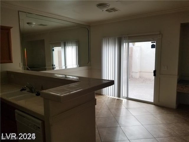 kitchen featuring sink, tile countertops, light tile patterned floors, ornamental molding, and kitchen peninsula