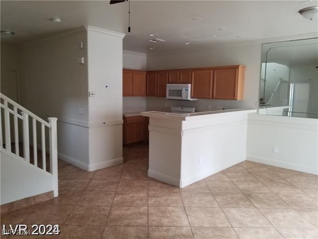 kitchen with crown molding, ceiling fan, kitchen peninsula, and light tile patterned flooring