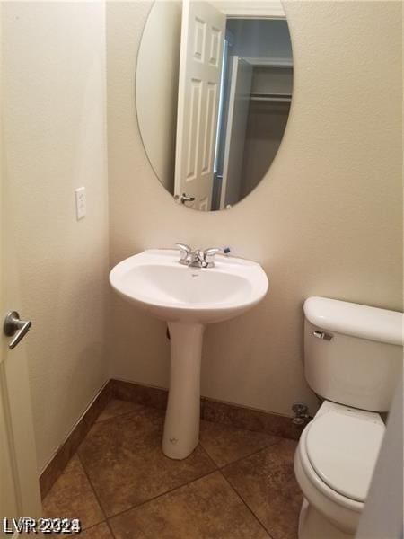 bathroom with tile patterned flooring and toilet