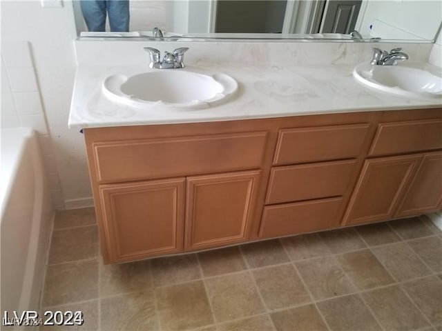 bathroom featuring vanity and a tub to relax in