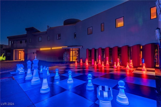 view of pool at twilight