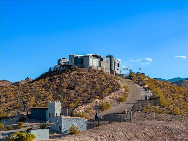 surrounding community with fence and a mountain view