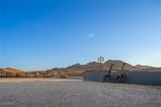 view of yard with a mountain view and fence