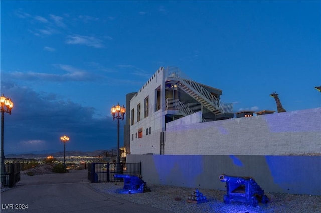 property exterior at dusk featuring fence