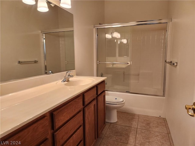 full bathroom with enclosed tub / shower combo, tile patterned floors, toilet, and vanity