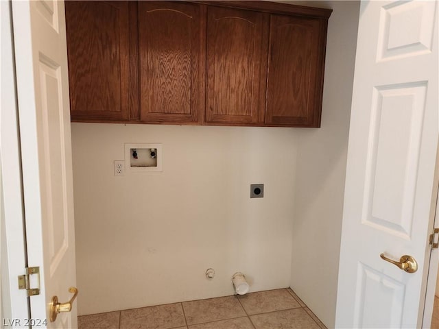 washroom featuring light tile patterned flooring, cabinets, washer hookup, hookup for an electric dryer, and hookup for a gas dryer