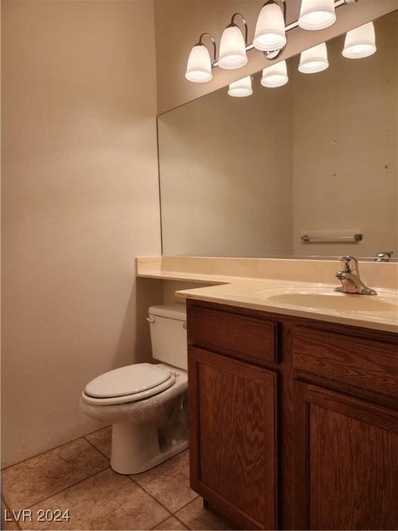 bathroom featuring vanity, toilet, and tile patterned flooring