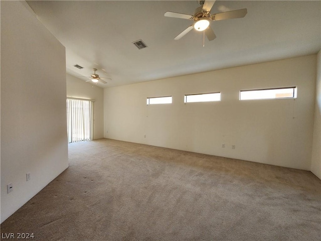 spare room featuring light carpet and ceiling fan