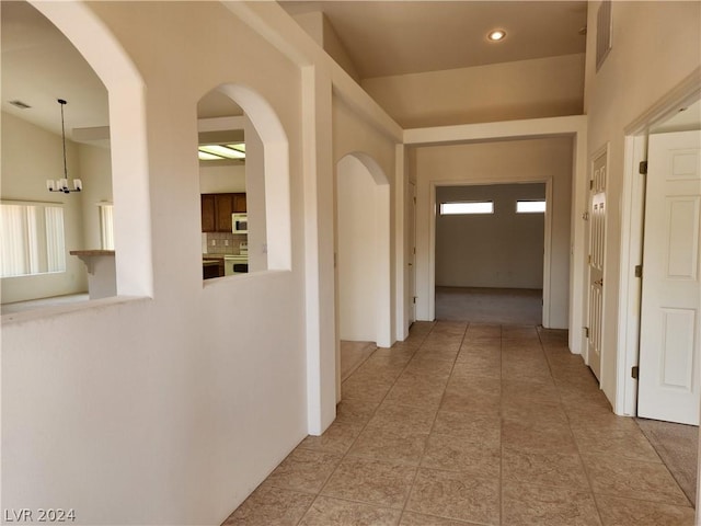 hall with light tile patterned floors