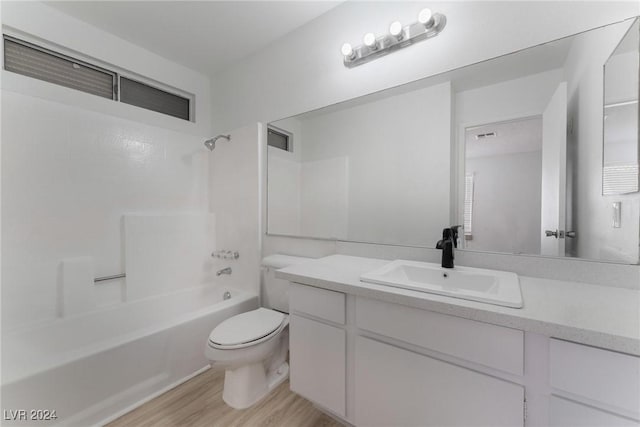 full bathroom featuring toilet, hardwood / wood-style floors, vanity, and shower / bathing tub combination