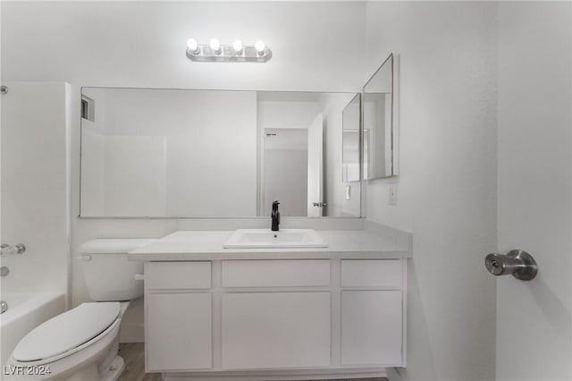 full bathroom with shower / washtub combination, wood-type flooring, vanity, and toilet