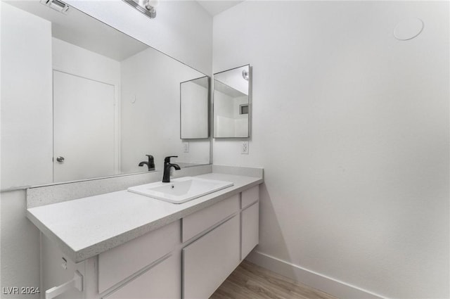 bathroom featuring vanity and wood-type flooring