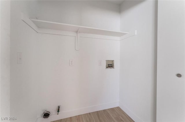 laundry area featuring gas dryer hookup, hookup for a washing machine, and light hardwood / wood-style flooring