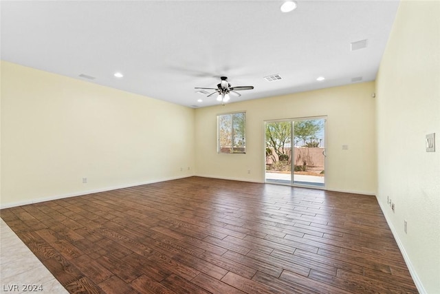 unfurnished room featuring recessed lighting, visible vents, dark wood-type flooring, ceiling fan, and baseboards