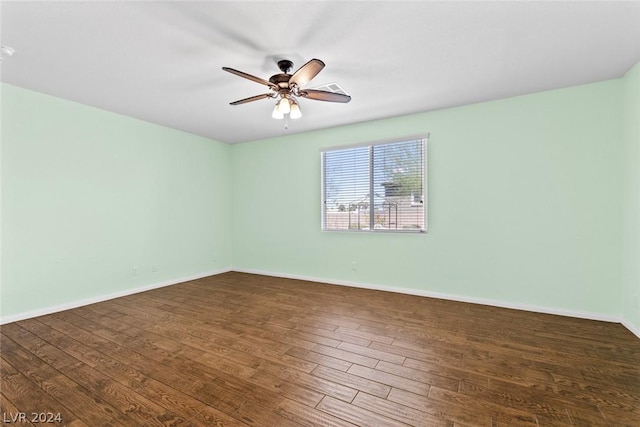 spare room with ceiling fan, baseboards, and wood finished floors