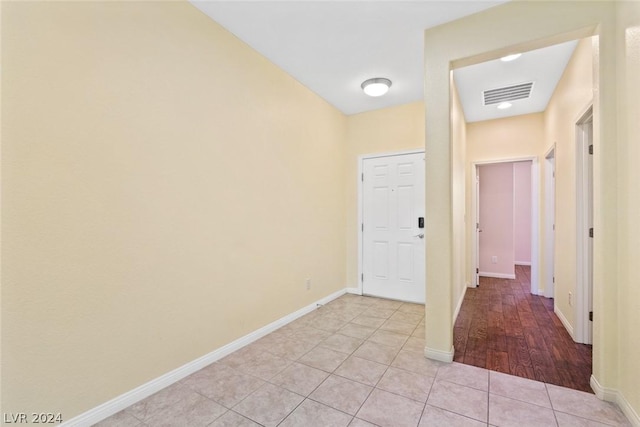 interior space with visible vents, baseboards, and light tile patterned floors