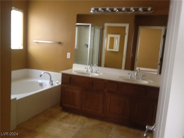 bathroom featuring tile patterned flooring, vanity, and shower with separate bathtub