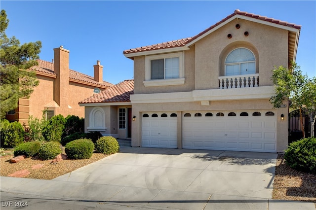 mediterranean / spanish-style home with a garage