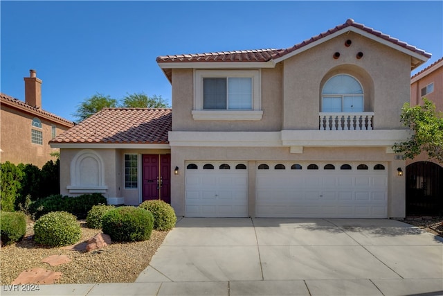 mediterranean / spanish house with a garage