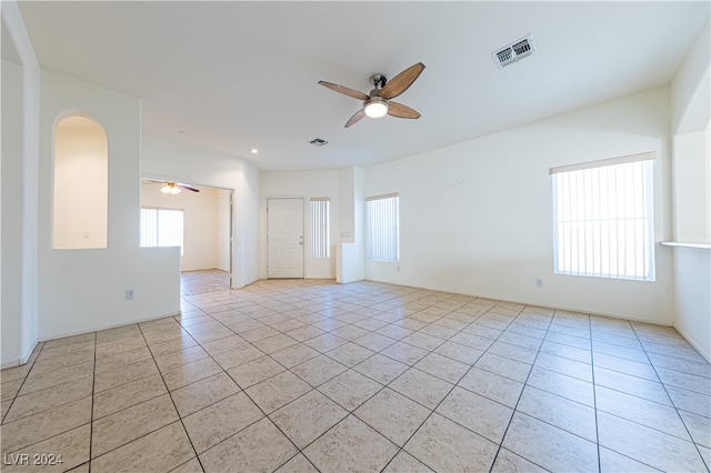 tiled spare room with ceiling fan