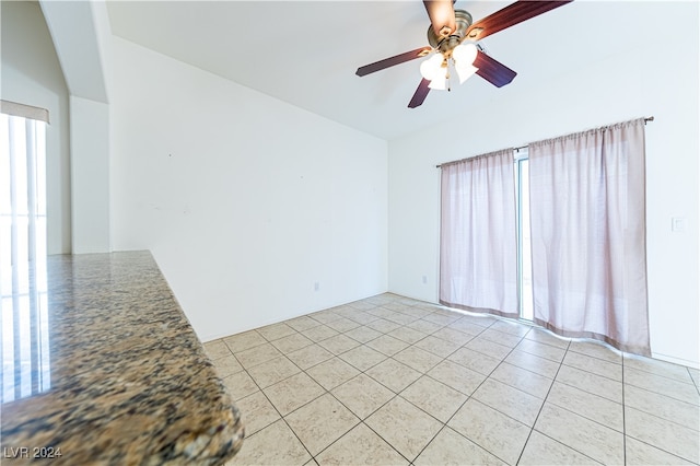 tiled empty room with ceiling fan