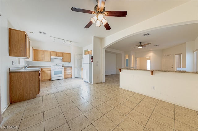 kitchen featuring white appliances, sink, light tile patterned floors, rail lighting, and ceiling fan