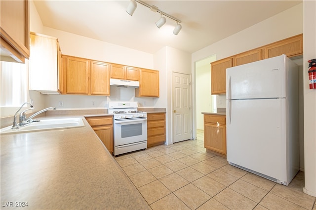 kitchen featuring track lighting, sink, white appliances, and light tile patterned floors