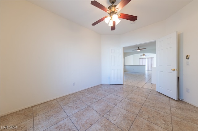 tiled empty room with ceiling fan