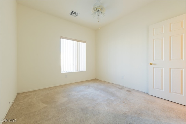 empty room with light colored carpet and ceiling fan