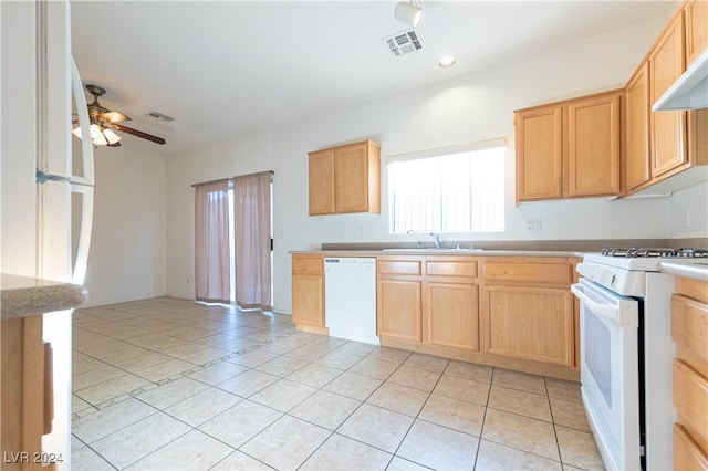 kitchen featuring white appliances, visible vents, light countertops, and a sink