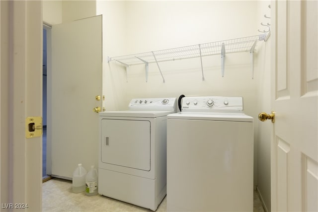 laundry area featuring washing machine and dryer and light tile patterned floors