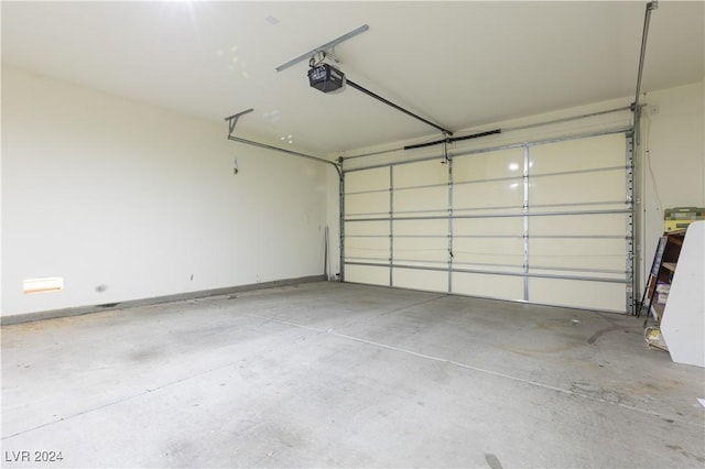 garage with baseboards and a garage door opener