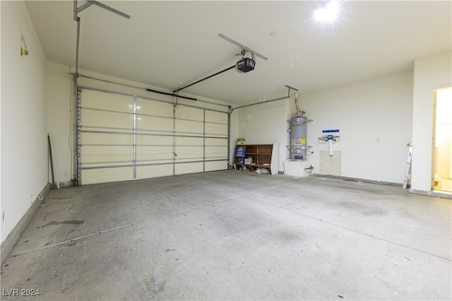 garage featuring a garage door opener and secured water heater