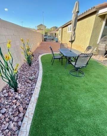 view of yard with a patio area and a fenced backyard