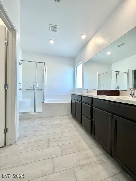 bathroom featuring vanity and separate shower and tub