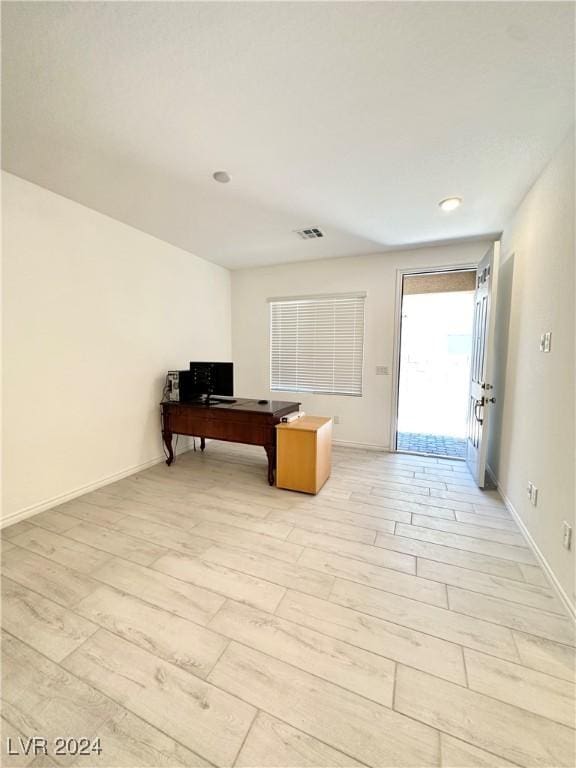 office with light hardwood / wood-style flooring