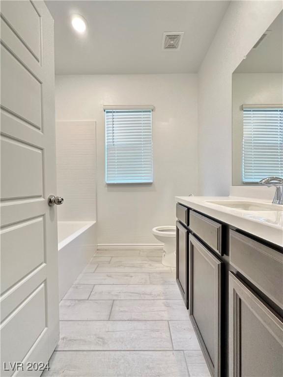 bathroom featuring vanity and toilet