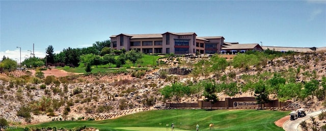 view of property's community featuring golf course view and a lawn