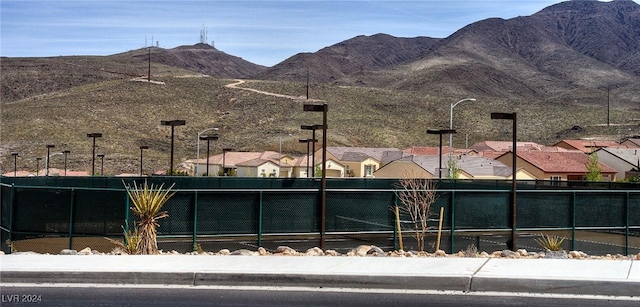 view of community featuring fence and a mountain view